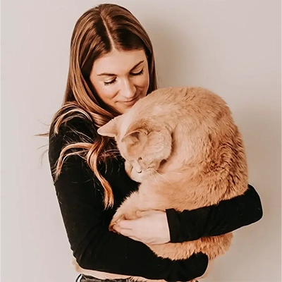 Angela Refuse, founder of My Grandfather's Cat, holding her cat.