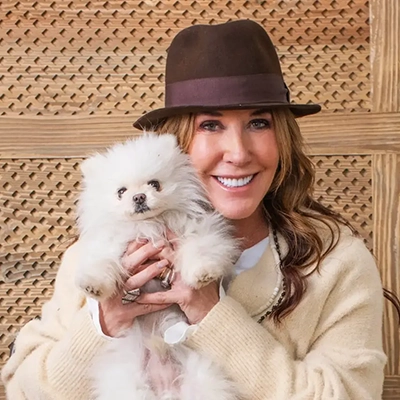 Dr. Christina Rahm, owner of Bill & Coo, holding a dog.
